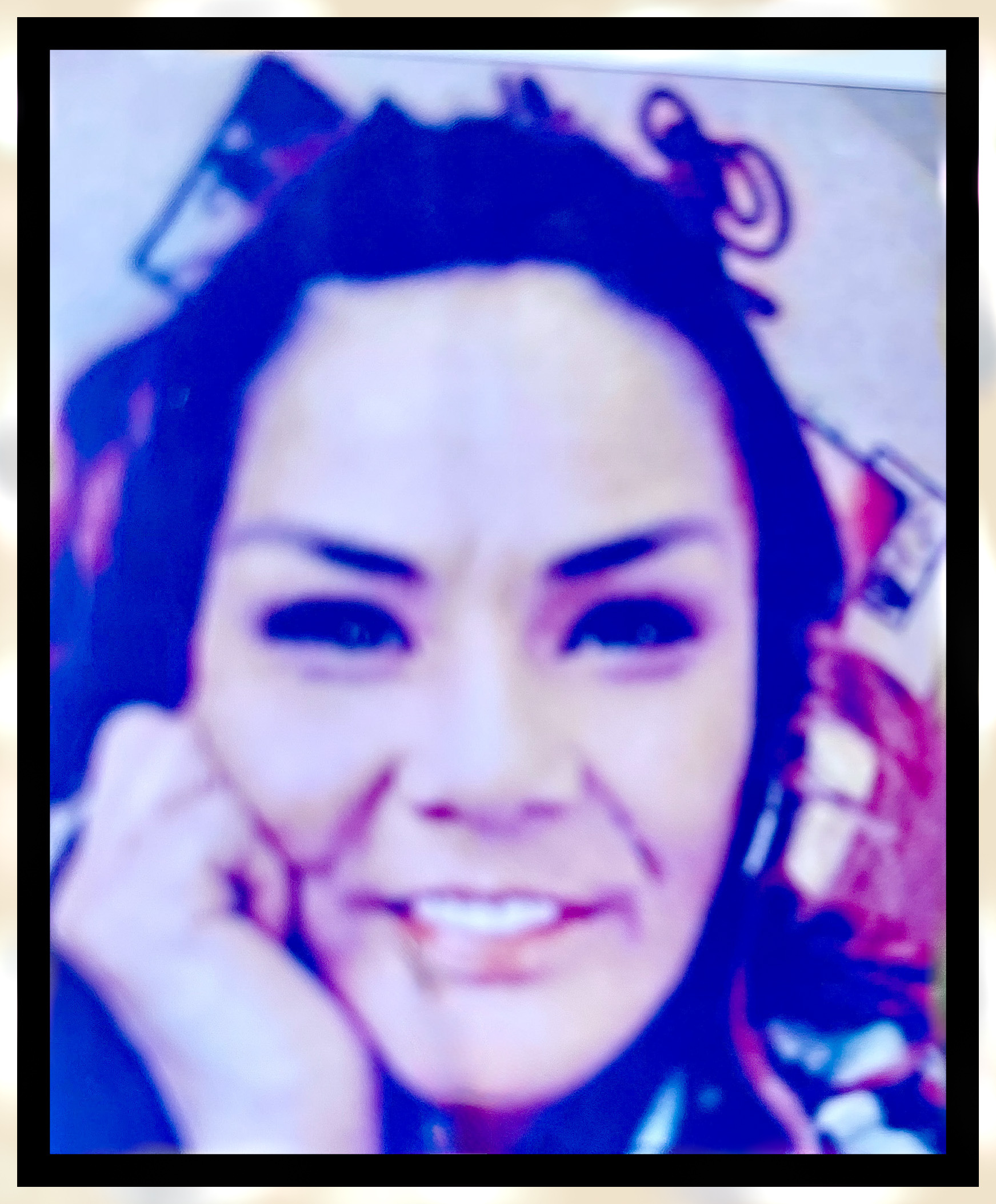 Camey DuBois Young woman with brown eyes looking into camera, smiling. Selfie